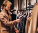 young-handsome-man-choosing-clothes-shop